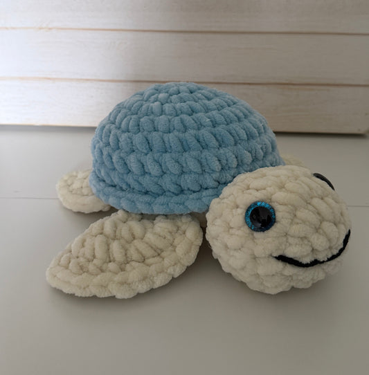 Crocheted turtle decoration on a white wall