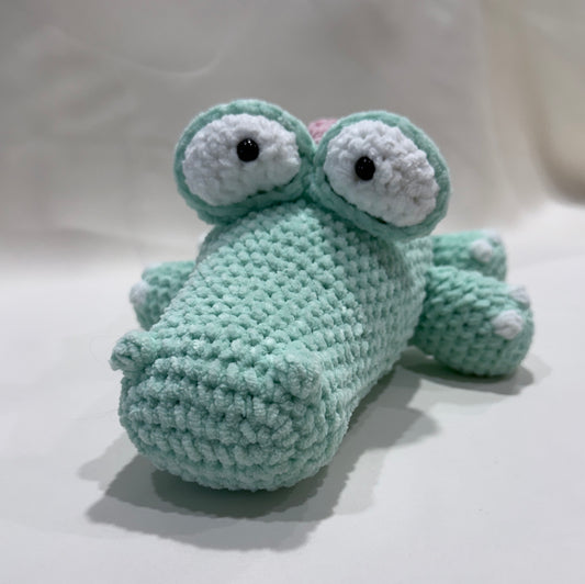 Crocheted crocodile on a white background