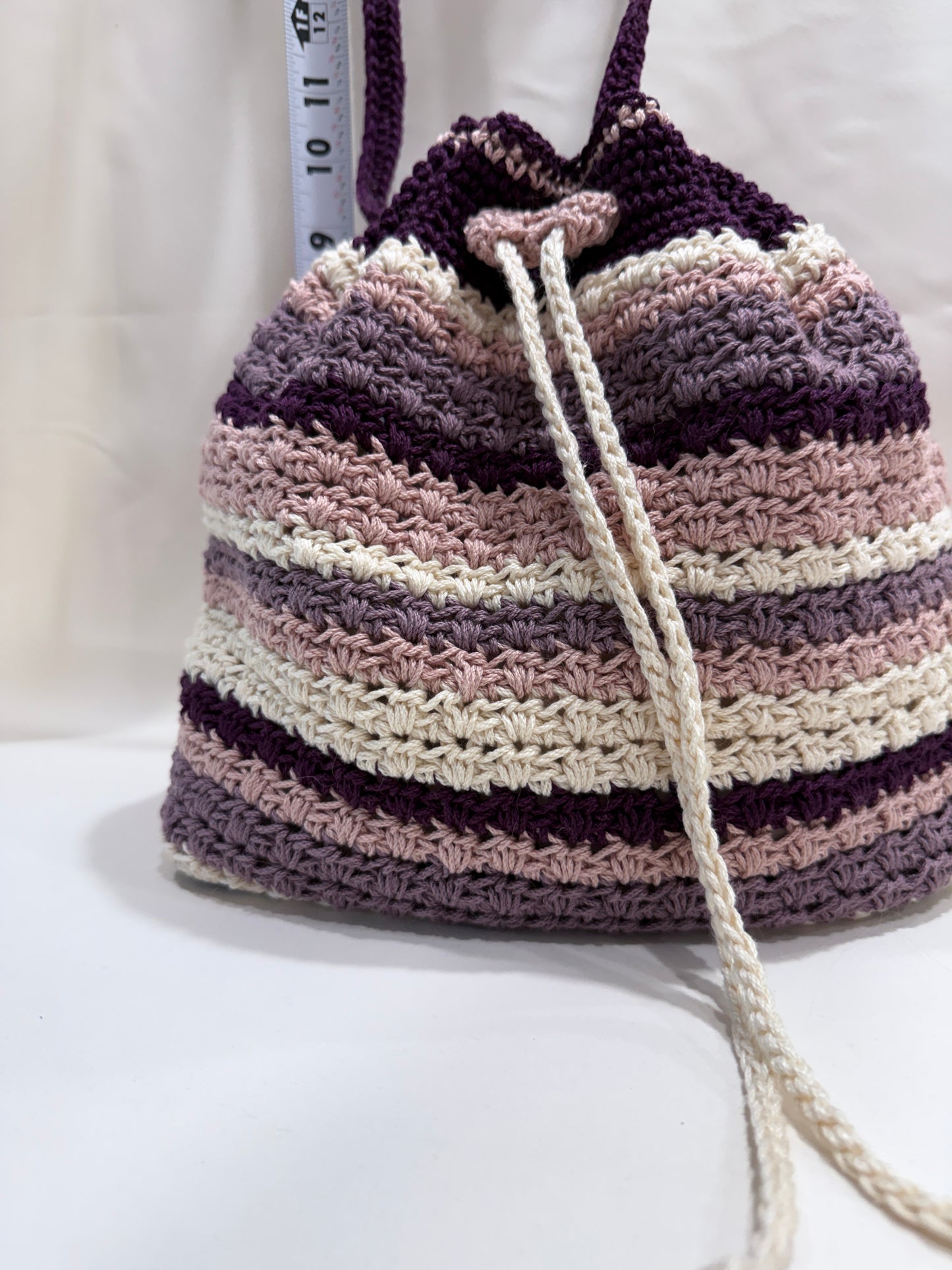 crochet bag with a striped pattern on a white background