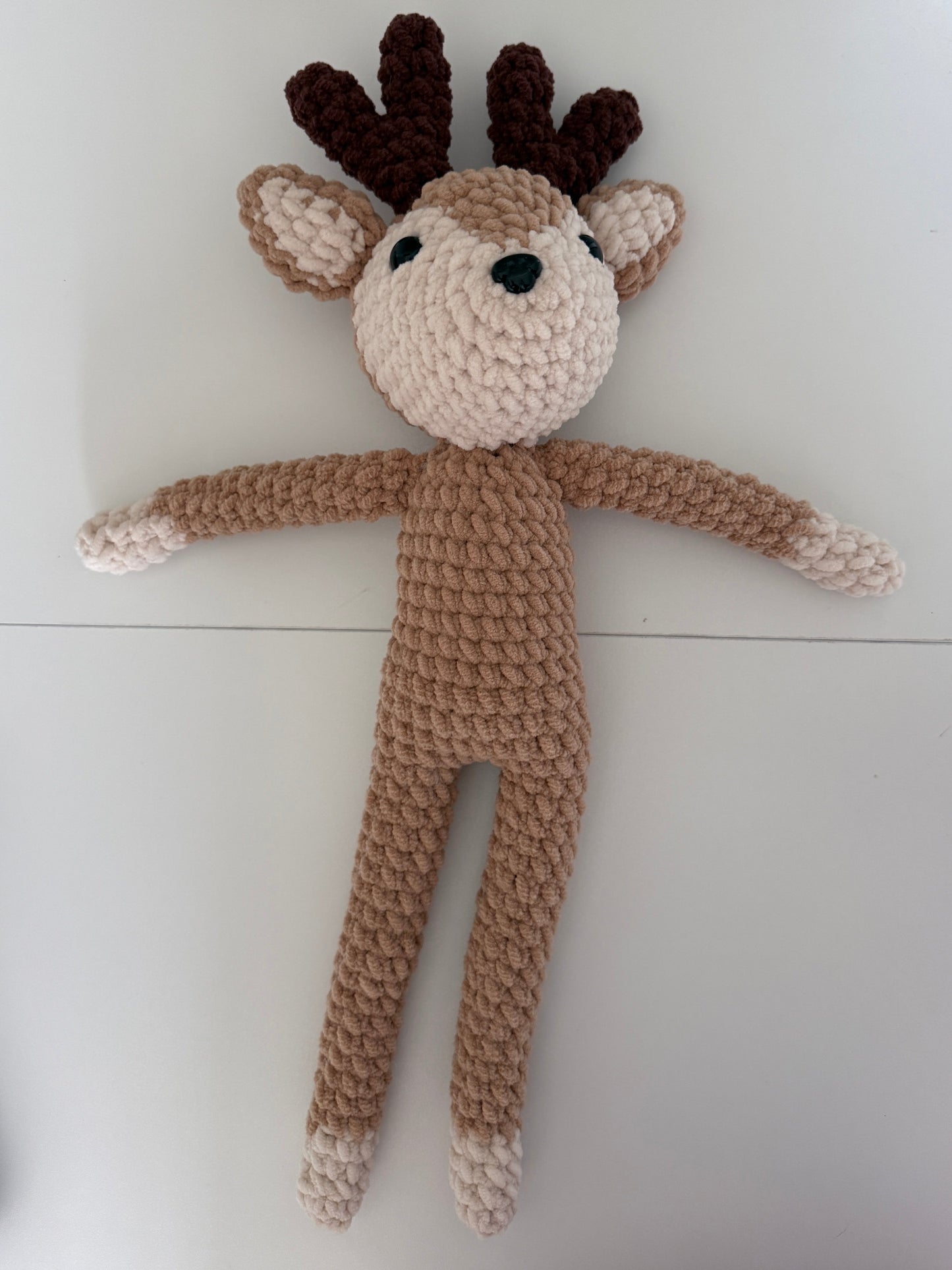 Crochet deer on a white surface