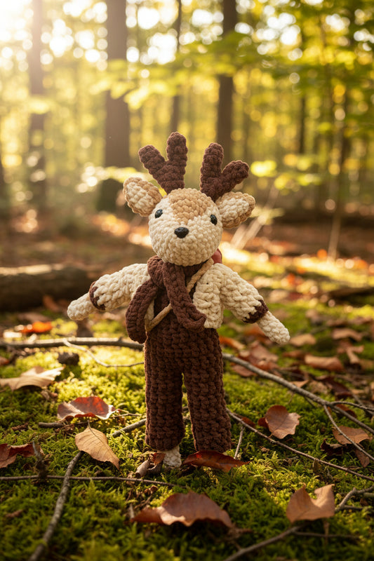 Crocheted deer in a forest setting