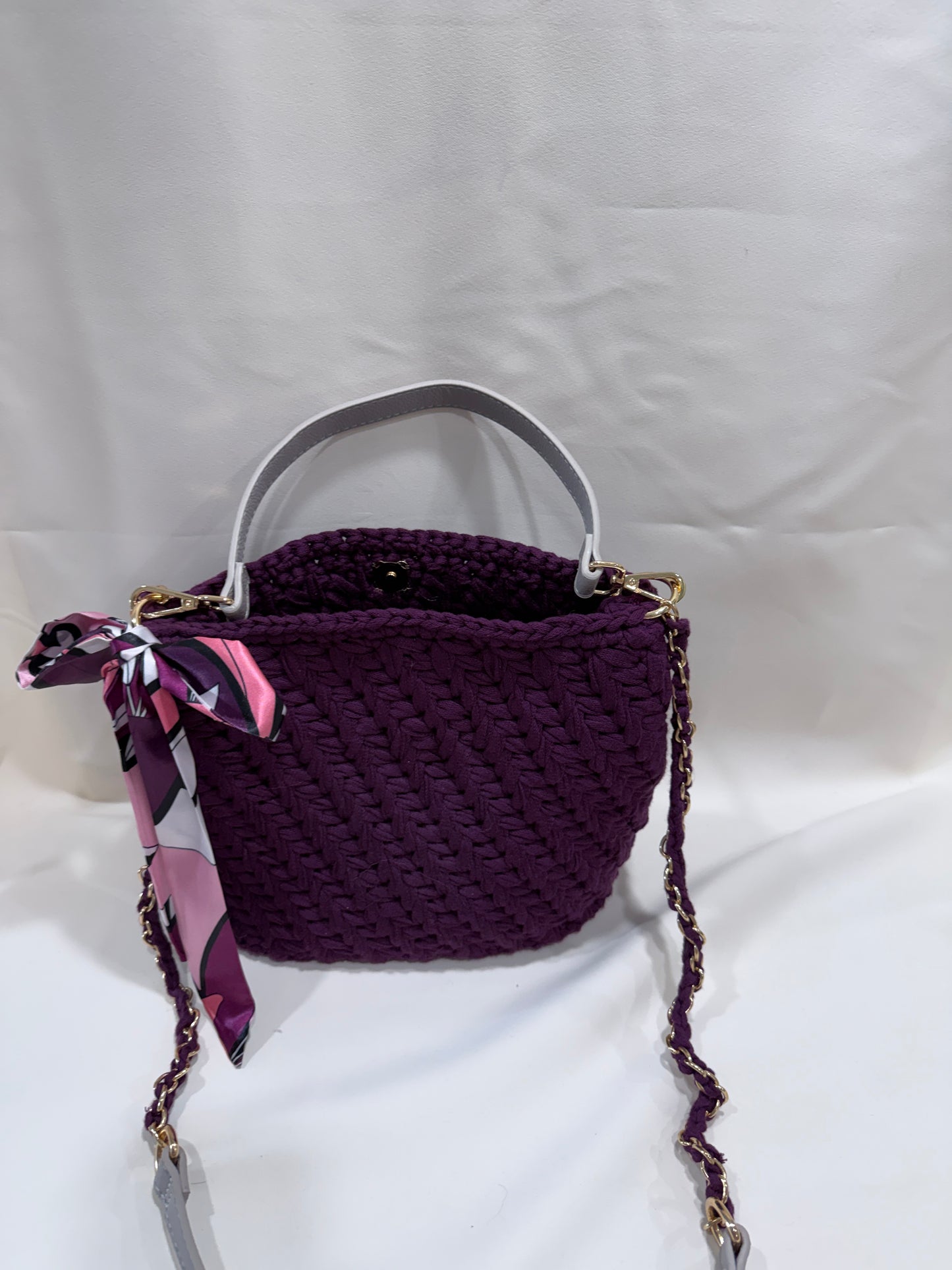 Plum crochet textured handbag with a matching scarf on a white background