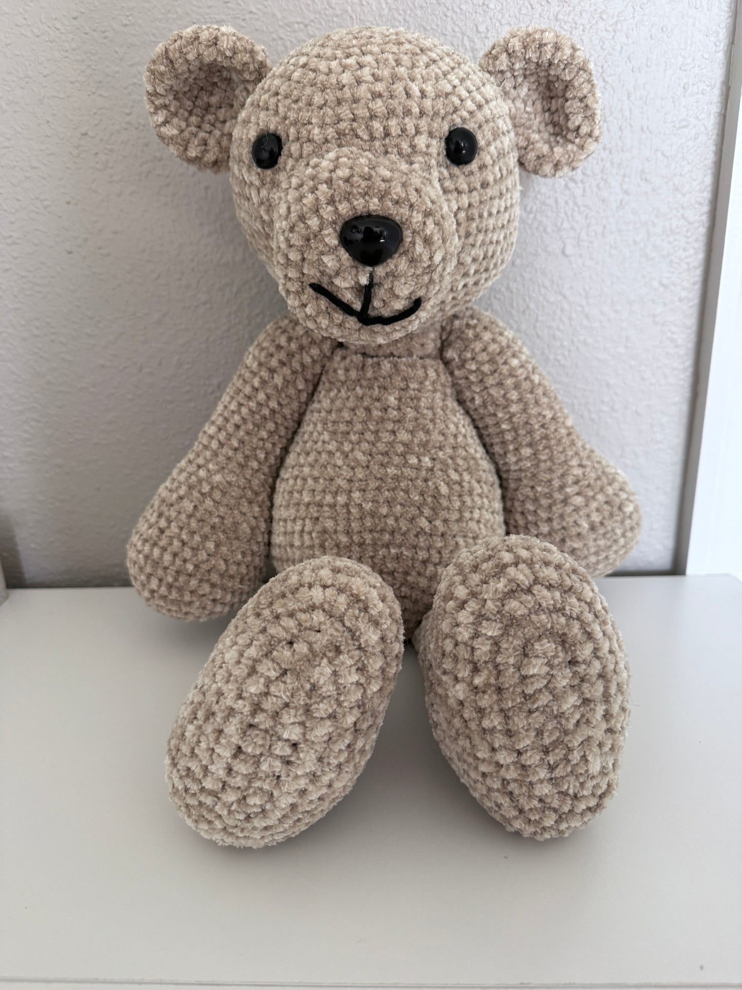 Crochet teddy bear on a white background
